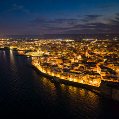 Aerial view of the old town of Monopoli in the Apulia region of Italy at night