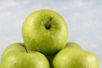 Image of five granny smith apples.