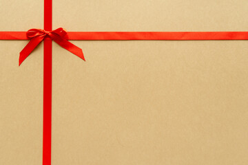 Christmas gift composition with red ribbin and bow. Flat lay, top view