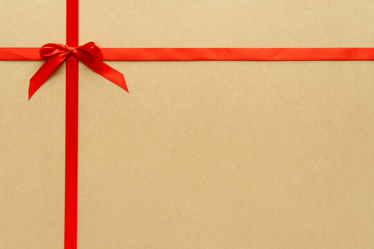 Christmas gift composition with red ribbin and bow. Flat lay, top view