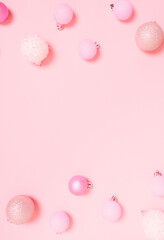Top view of Christmas composition on pastel pink background. Holiday greeting card with copy space to text.