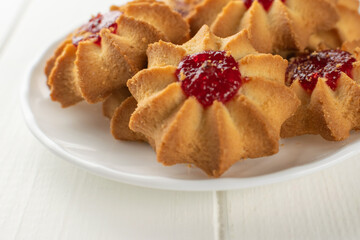 Delicious Star-Shaped Cookies with Raspberry Jam on White Plate