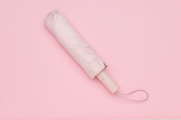 Compact Pink Umbrella on Minimalistic Pastel Background for Modern Lifestyle