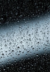 Macro view of heavy moisture beads clinging tightly to a cool pane, illustrating profound saturation and humidity levels ,weather ,dense ,saturated