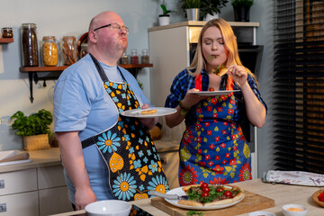 Cooking together joyfully, Shared cooking experiences bring happiness to couples working together, Cooking as team fosters happiness and unity among partners in kitchen