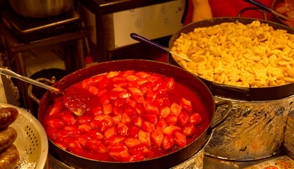 Korean street food tteokbokki and odeng cooking in large pots for sale