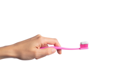 A hand holding a pink toothbrush with toothpaste applied 
