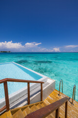 Fantastic luxury water villa infinity pool. Relaxing steps into calm turquoise sea lagoon. Summer vacation tourism background view. Famous destination resort travel. Sunshine blue sky idyllic outdoors