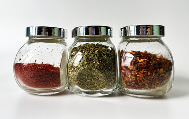 Spices in jars on a white background
