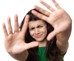 Portrait of a serious young woman showing stop gesture with her palm over white background