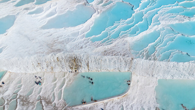 Aerial top view Pamukkale Turkey travertine pools, nature terraces with blue water.