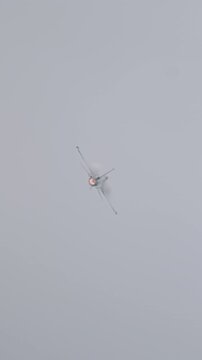 F-16 fighter jet performing maneuvers during an airshow demonstration