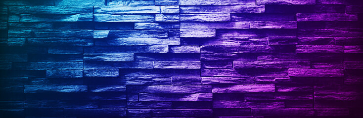 Black dark purple blue stone brick wall background. Bright light neon lighting.Color gradient.Green turquoise teal violet fuchsia magenta pink lilac белый.Night club disco bar party.Empty.Wide banner