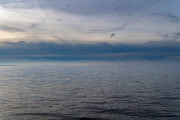 blue hour over Lake Constance Bodensee with blue water, dark blue clouds and sky with negative space for text