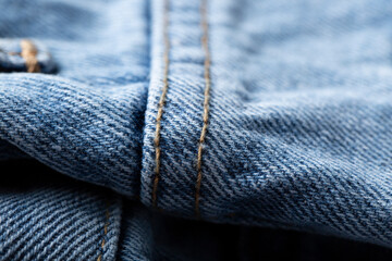 The denim is light blue. Denim background.
