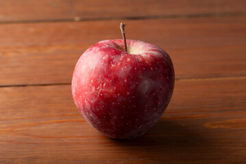 A red apple on a dark background.