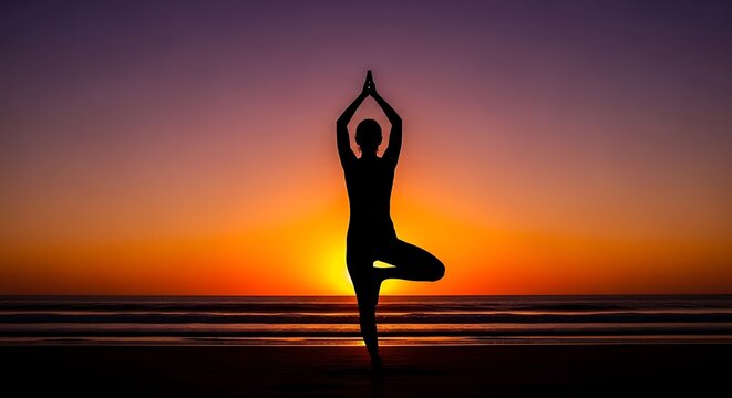 Silhouette of a person practicing yoga tree pose on a beach at sunset with vibrant orange and purple sky