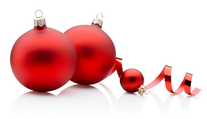 Three red Christmas baubles and curling paper ribbon isolated on white background