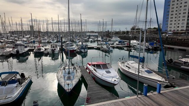 Pleasure boats and yachts moored in Gosport Marina. Pan left