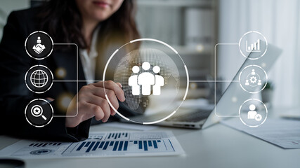 Business teamwork connected around a globe representing cooperation, leadership, and organizational...