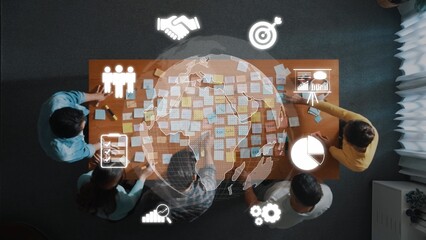 A diverse group of individuals engages in a collaborative strategy session. They analyze data and...