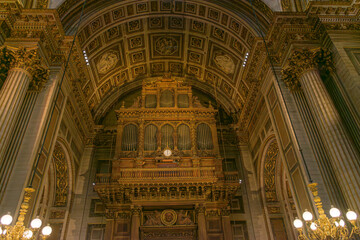 Fototapeta premium Grand organ of the Madeleine Church in Paris, built by Aristide Cavaille-Coll in 1846, featuring gilded Neoclassical architecture