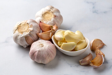 Bulbs and cloves of fresh garlic on table, closeup