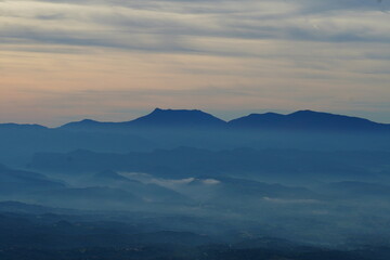 Mountain landscape with misty valleys and soft morning light