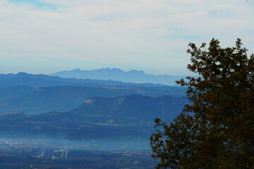 Mountain landscape with misty valleys and soft morning light