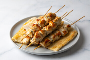 Chicken shish kebab or Greek grilled chicken skewers - chicken souvlaki served with lemon