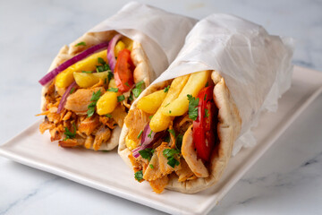 Greek chicken gyros wrapped in pita breads