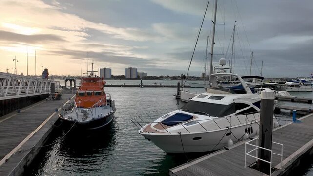 A former lifeboat and a pleasure cruiser mkoored in the harbour, Portsmouth