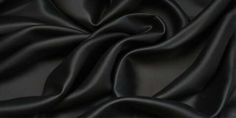 Fototapeta premium Black silk satin background. abstract black silk texture background with flowing wavy patterns and smooth 