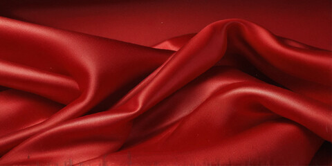 red satin silk, elegant fabric for backgrounds, beautiful red textile cloth background. detail of wavy red silk fabric background.
