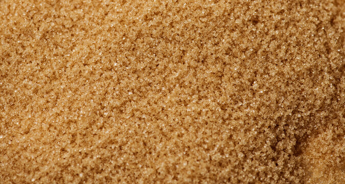 Brown Cane sugar background close up. Brown sugar backdrop, texture. Heathy eating, diet concept. Top view, flat lay