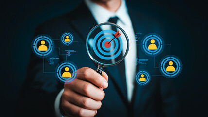 Professional analyzes target audience with magnifying glass showing bullseye and connected user icons for strategic business planning and marketing campaigns.