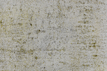 Dirty wall with dark stains, discoloration, and natural weathering. Grungy aged surface ideal for backgrounds, design textures, or architectural detail projects