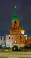 The Odoevsky Gate Tower of the Tula Kremlin with bright night illumination. A majestic view of a historic monument of Russian defensive architecture against a dark sky in Tula, Russia.
