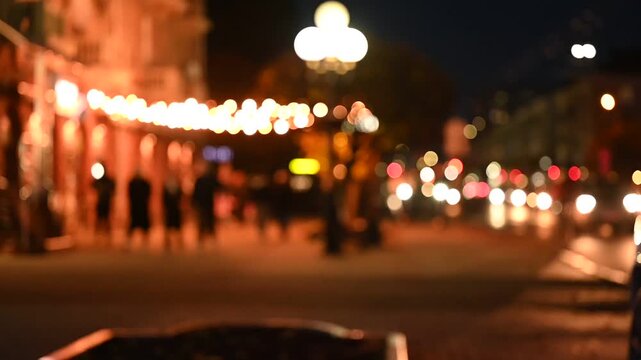 evening city in the light of lanterns and car headlights