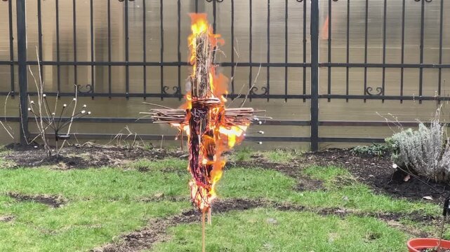 Burning straw effigy in field symbolizing traditional Russian spring ritual purification farewell to winter and beginning of new life. Visual metaphor for cleansing renewal and emotional