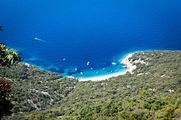 Amazing Lubenice beach, almost only accessible by the sea, with its turquoise waters and sand shore, below steep slopes of Cres island, Croatia