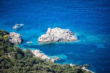 Beautiful, turquoise sea and secluded beach beneath the village of Lubenice, high above on the hill...