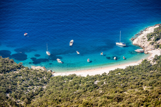 Amazing Lubenice beach, almost only accessible by the sea, with its turquoise waters and sand shore, below steep slopes of Cres island, Croatia