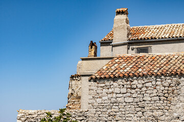 Old, stone houses with aged facades in the small village of Lubenice, high on the Cres island mountains, Croatia