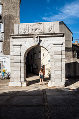 Old stone Porta Marcella gate in the town of Cres, Croatia