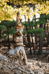 Tall stone stack on the Cres island beach, Croatia, built during summer vacation by the unknown tourist