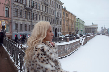 Young luxury blonde hair woman in stylish fashion winter coat