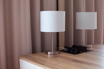 Modern bedside lamps and charging station in a hotel room