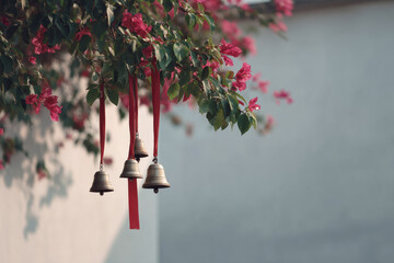 delicate bells hanging from ribbon create whimsical ambiance in blossoming spring garden
