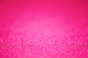 Pink defocused glitter background with thin focus part and defocused main part.